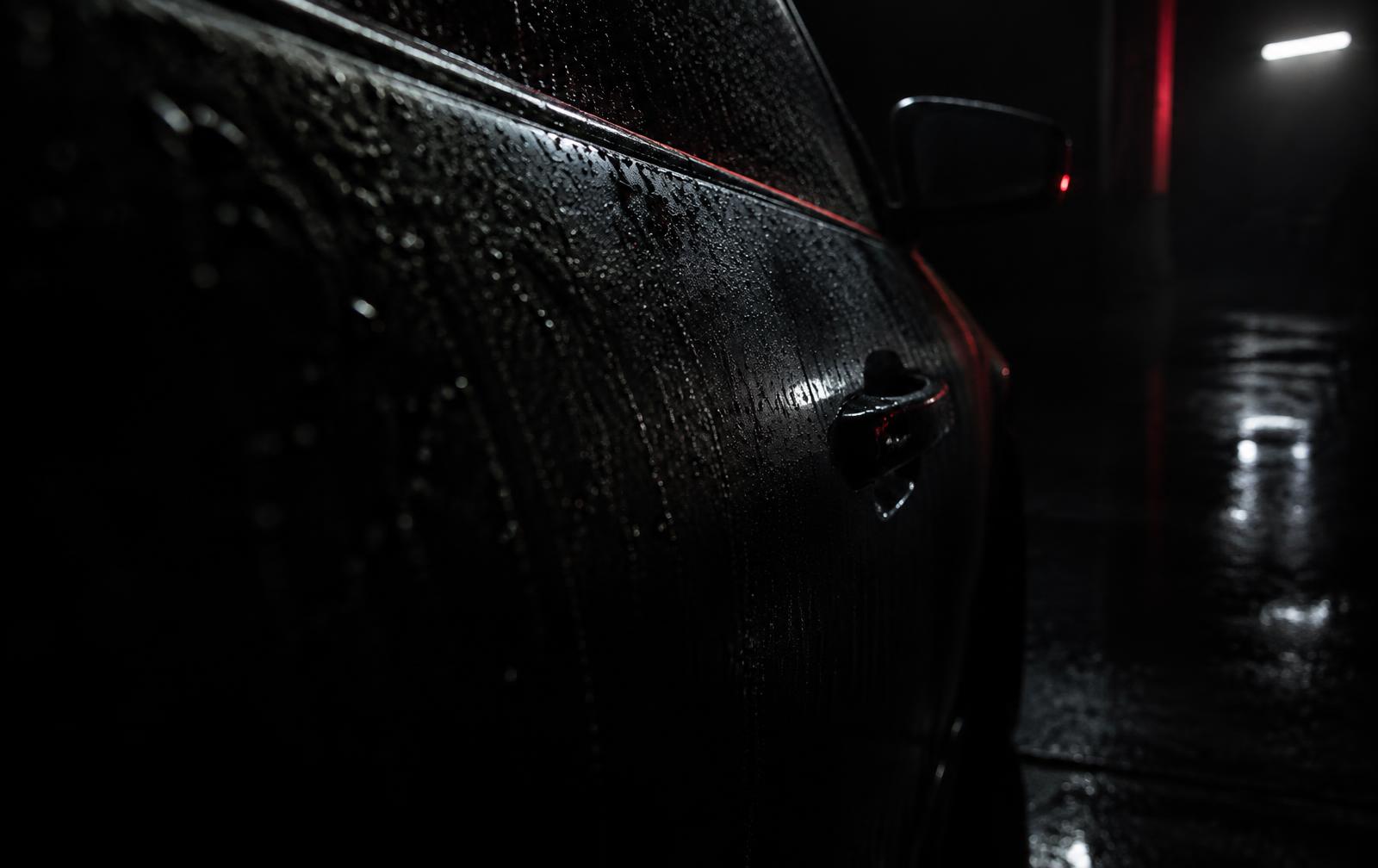 Water beading tight on the corrected, ceramic coated paint of a dark car in Bolingbrook, IL