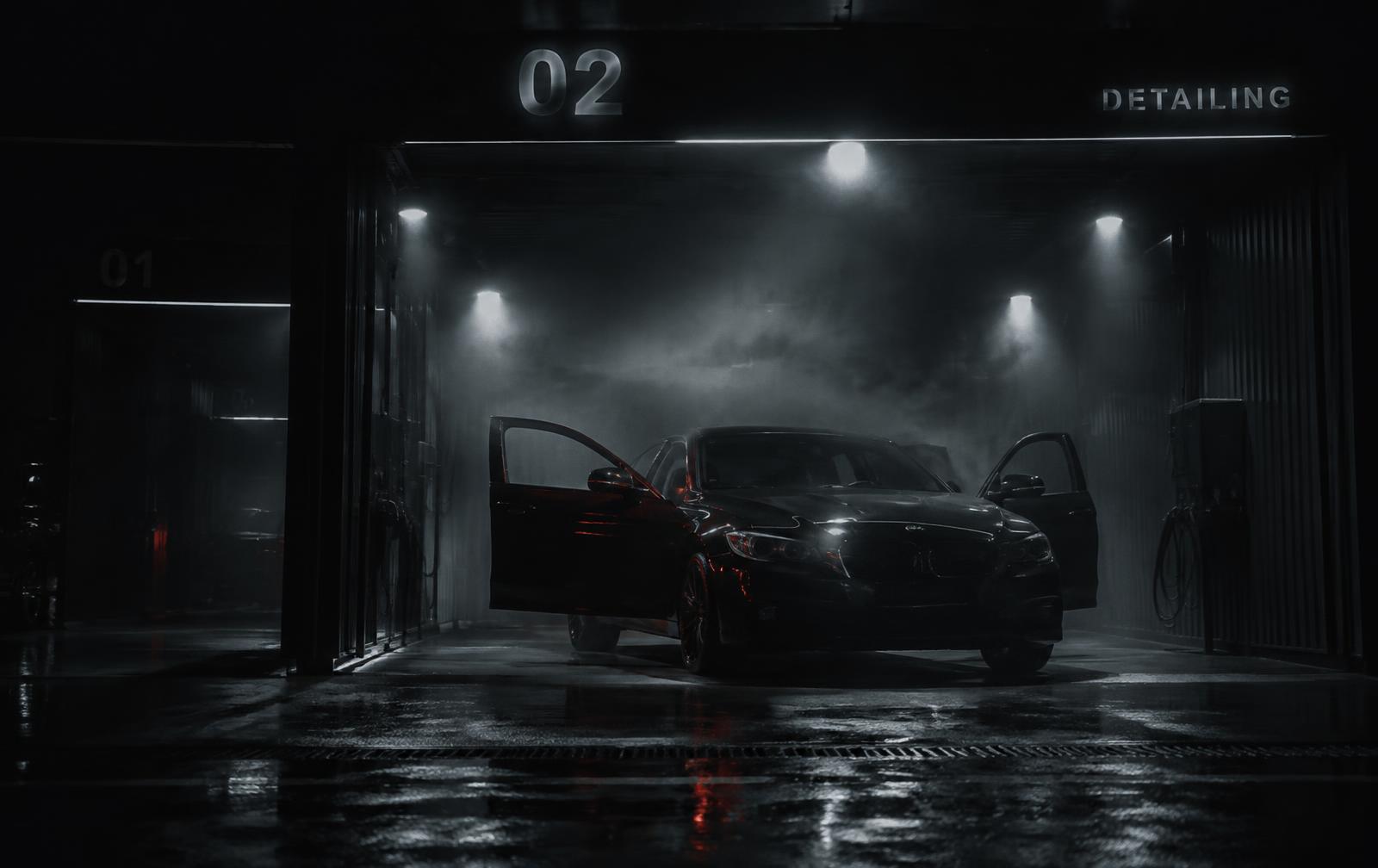 Dark sedan with doors open under the lit detailing bay at Empire Detailing in Bolingbrook, IL, during a full interior and exterior detail